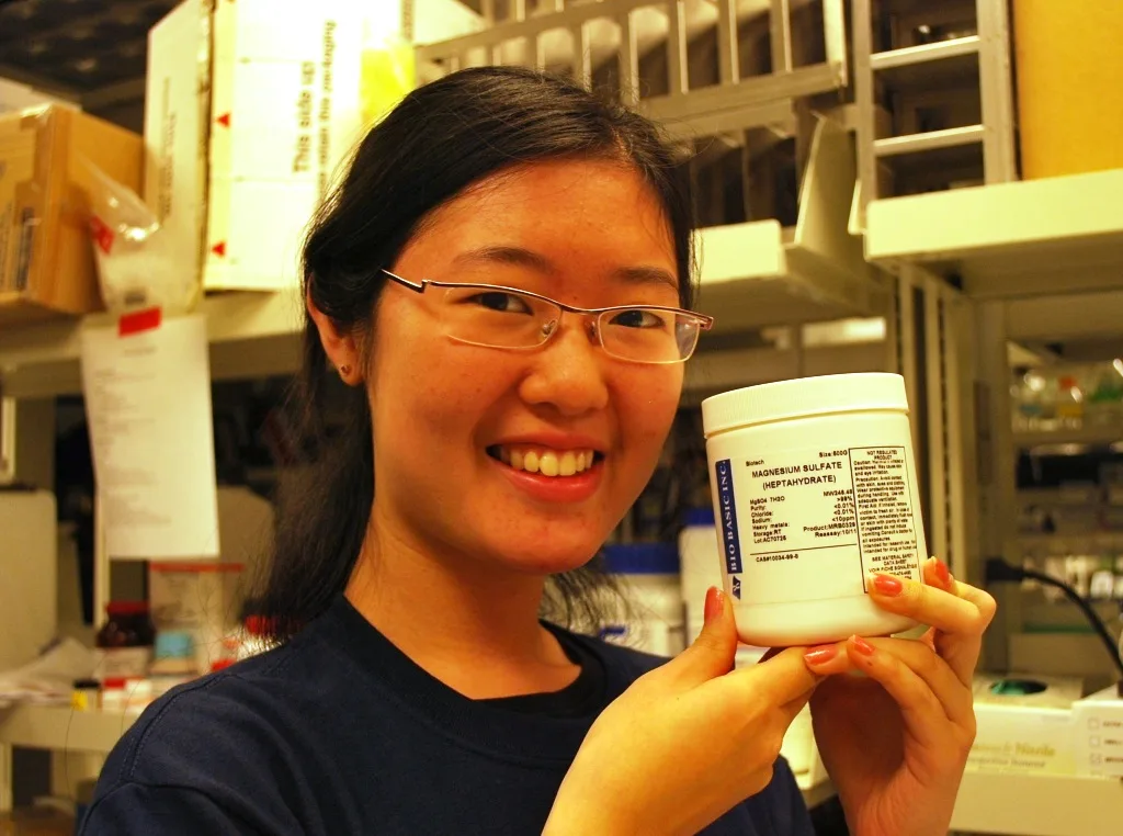 Holding a jar of magnesium sulfate in the lab