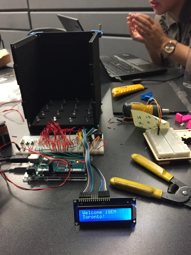 Hardware prototype build, dry lab — display reads 'Welcome iGEM Toronto!'