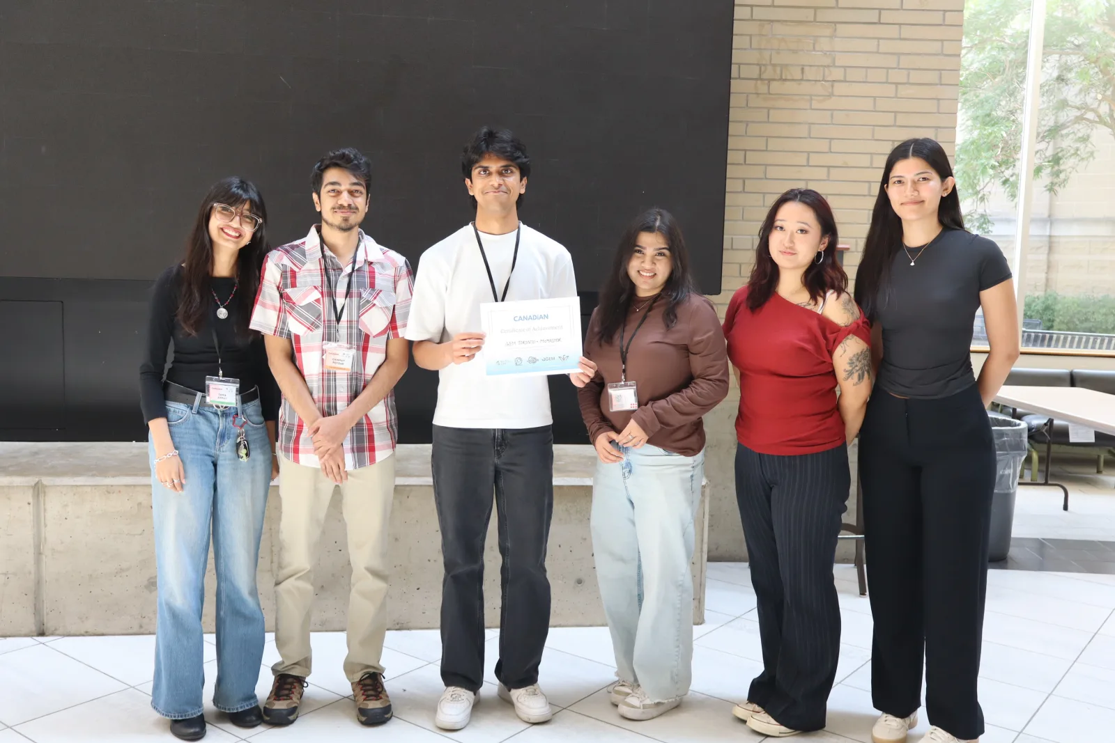 Second group photo with the Great Canadian Meetup award, McMaster University, 8–9 August 2026