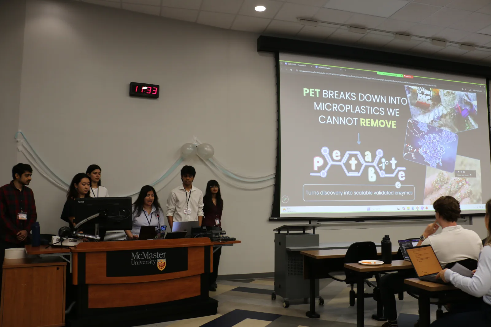 Team pitches its PET-degrading enzyme project at the Great Canadian Meetup, McMaster University, 8–9 August 2026 — second place overall, with Best Engineering Approach and Best Experimental Evidence awards