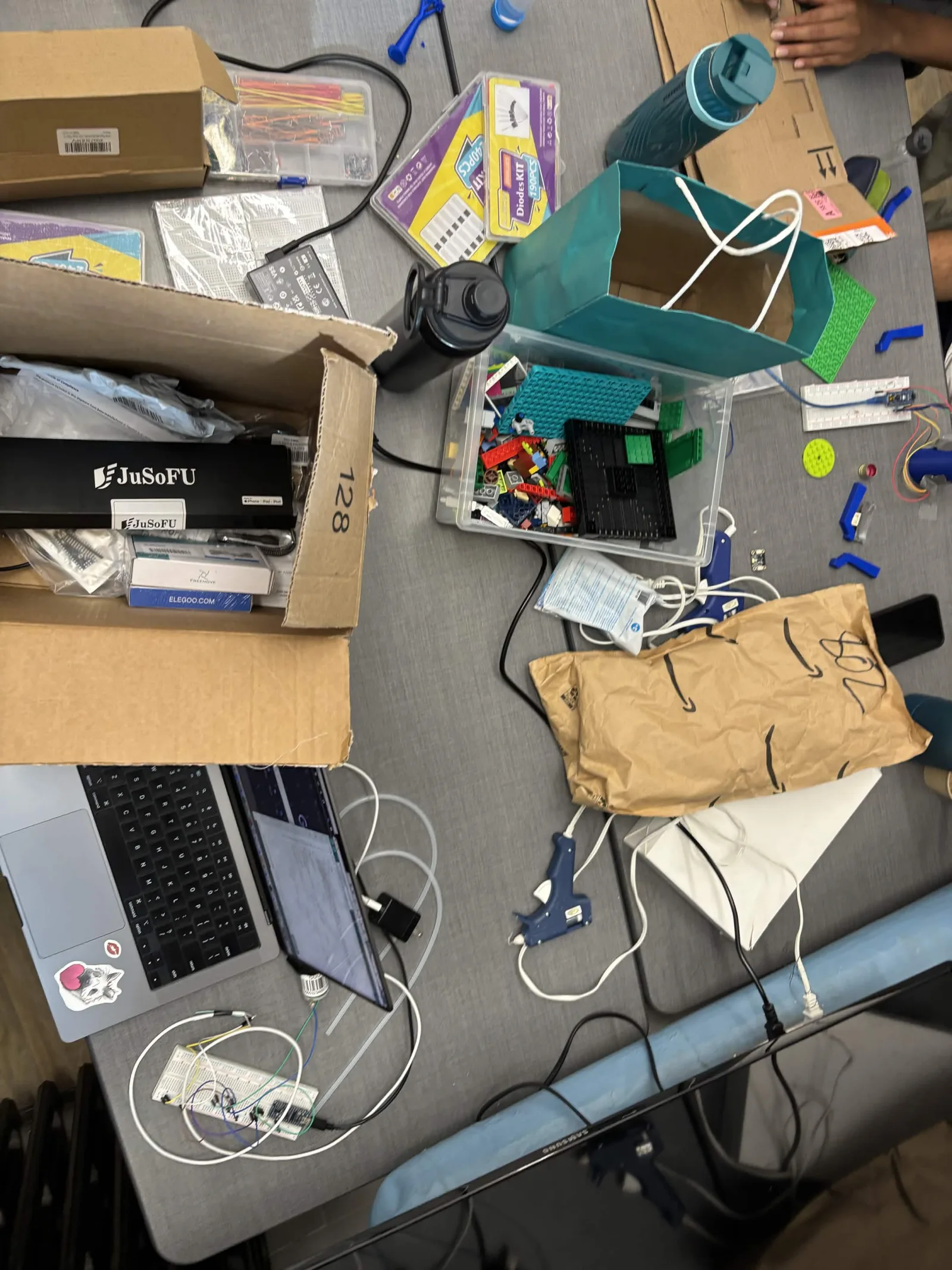 Hardware team workbench prototyping the bioreactor's subsystems ahead of the 30 July integration deadline