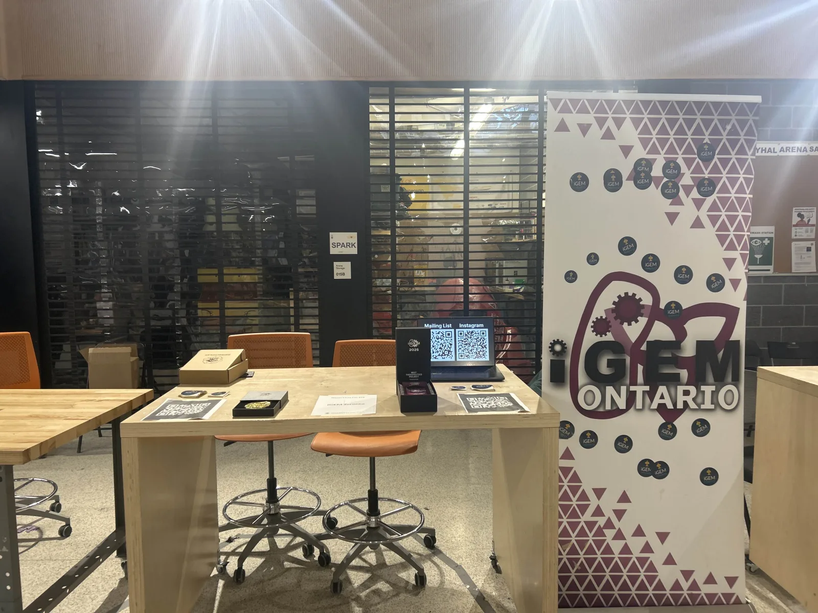 iGEM Toronto booth set up with mailing-list sign-up and past awards on display, January 2026