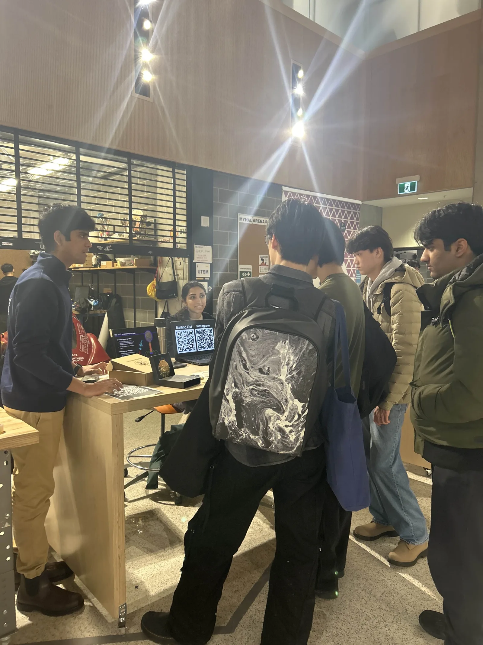 Students crowd around the iGEM Toronto booth during a campus fair, January 2026