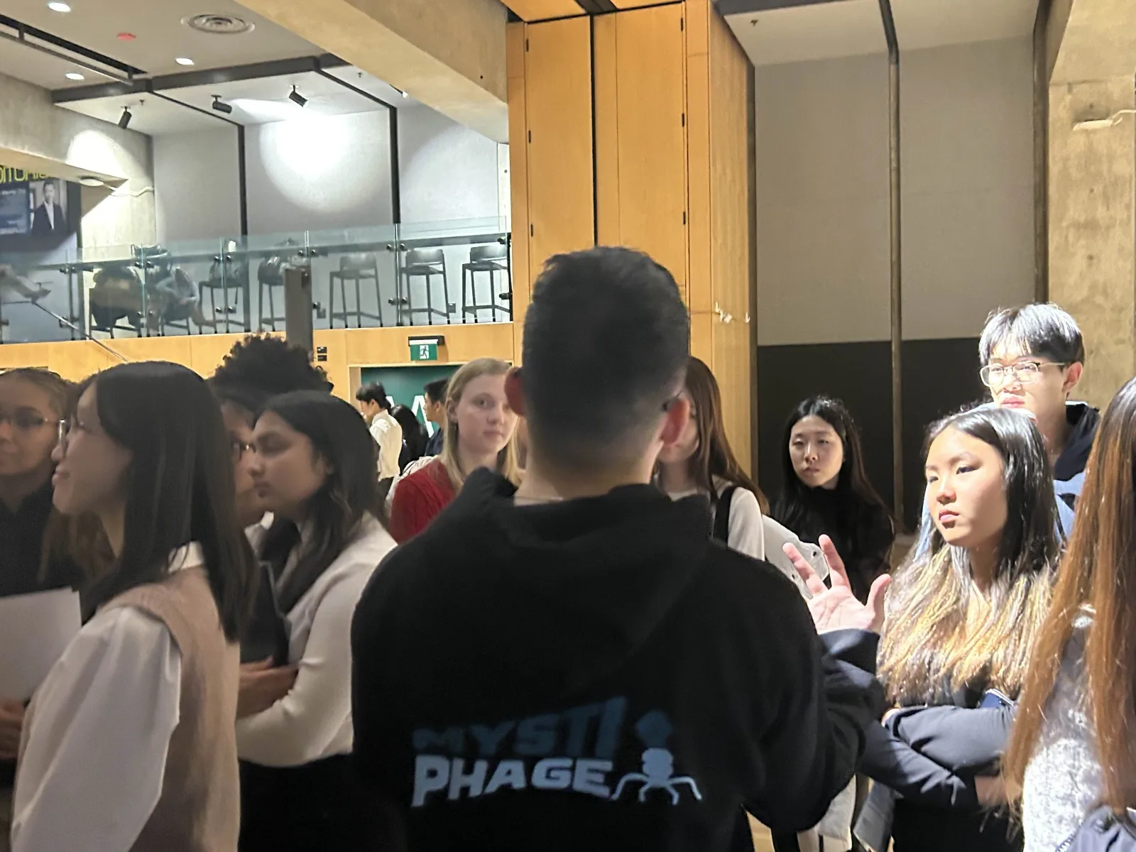 Team member speaks with a crowd of students about the Mystiphage project, February 2026