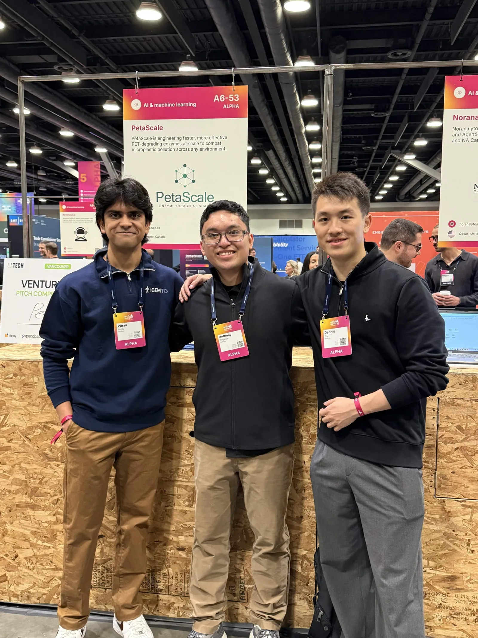 Team members at the PetaScale booth in the AI & machine learning startup hall — Web Summit Vancouver