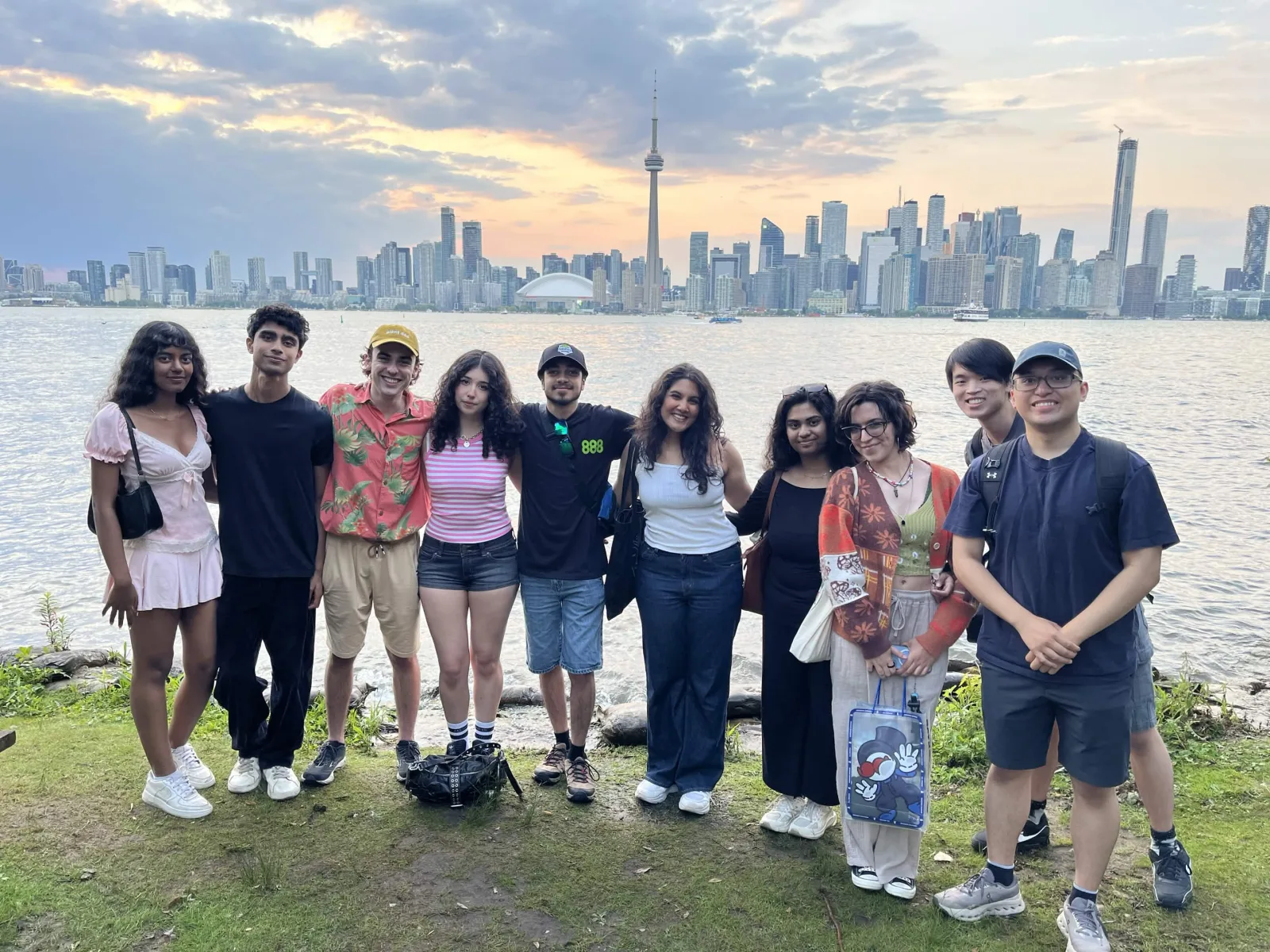Team photo on the Toronto Islands at sunset, 26 July 2026 — skyline behind.