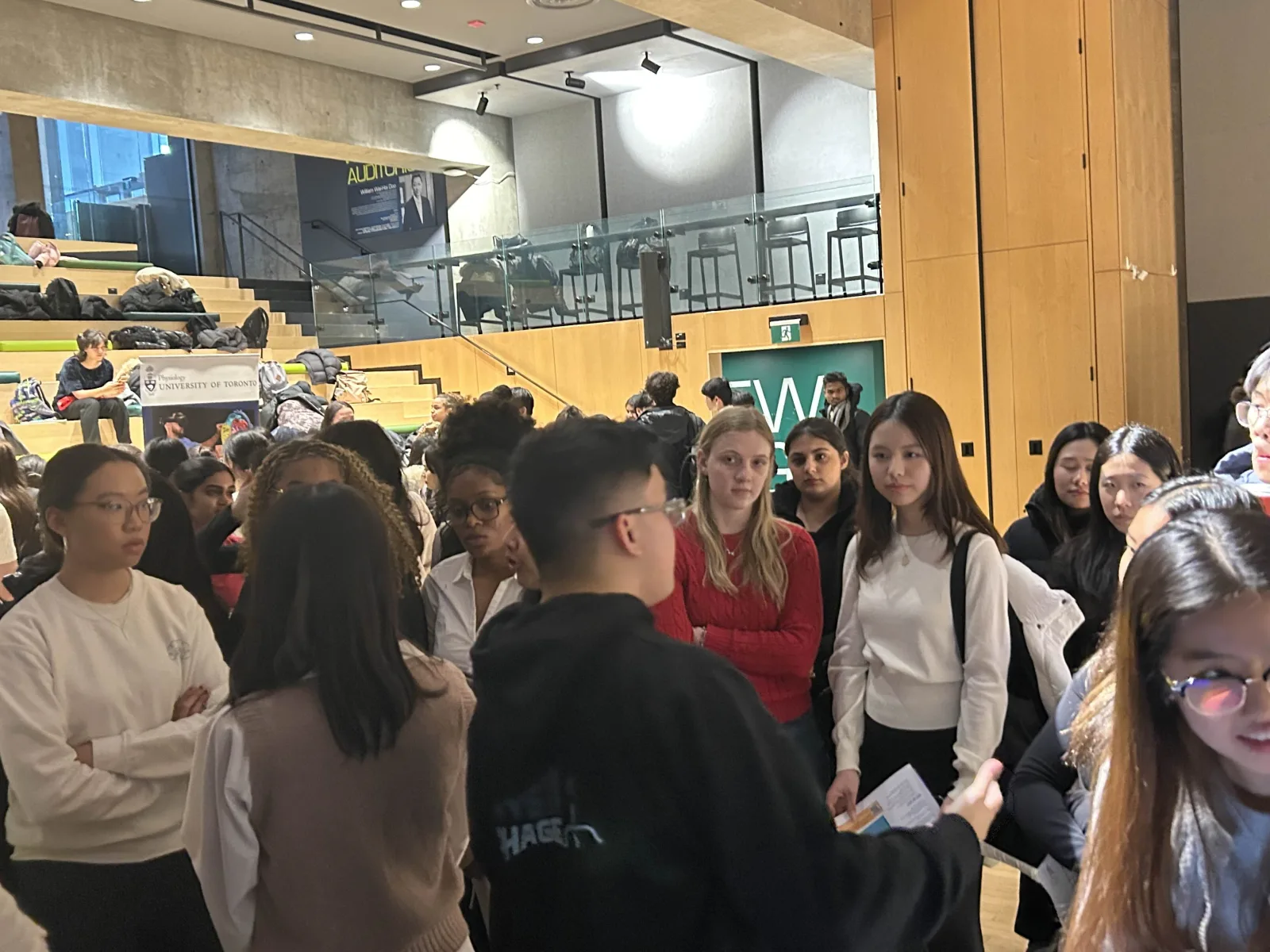 Students fill a university lobby during a project showcase event, February 2026
